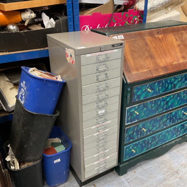 Vintage metal filing cabinet for office document storage.