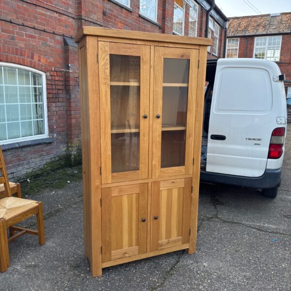 Large oak display cabinet with glass front, vintage style.