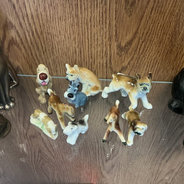 Miniature porcelain dog figurines in a collection, vintage animal sculptures.