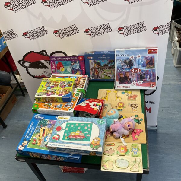Assorted puzzle collection including wooden and Disney puzzles.