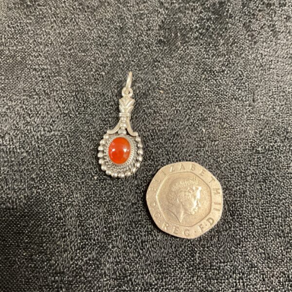 Vintage silver pendant with amber floral design.