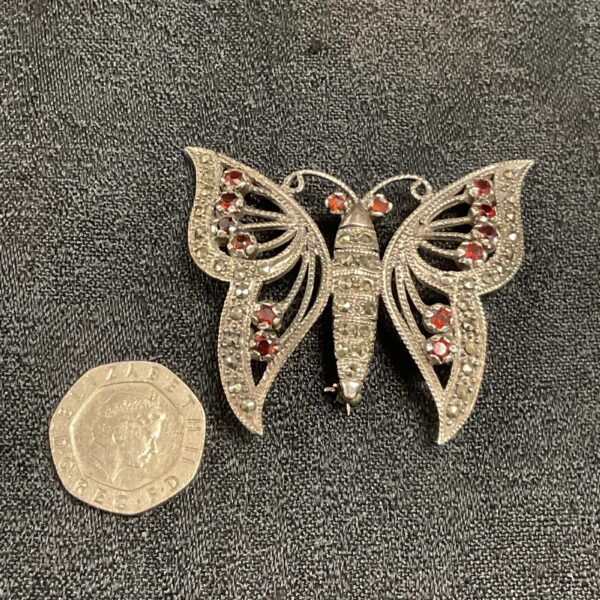 Vintage silver butterfly brooch with marcasite and garnet details.