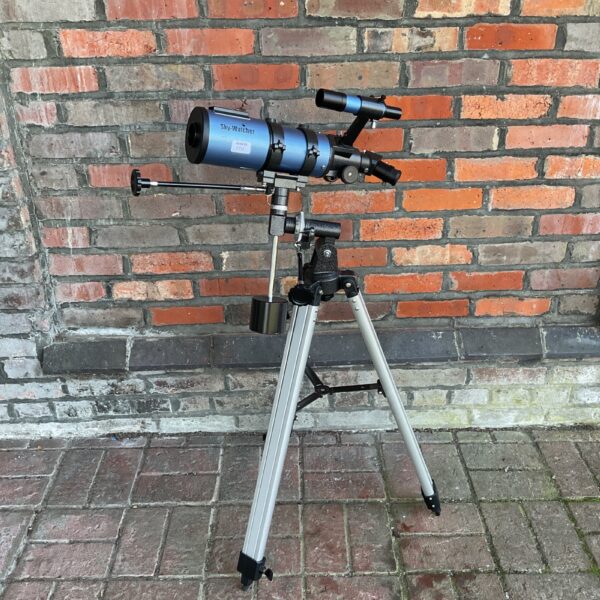Blue Skywatcher telescope mounted on a silver tripod for astronomy.