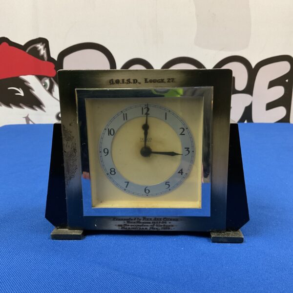 Vintage Temco Masonic mantle clock with black base and white face.