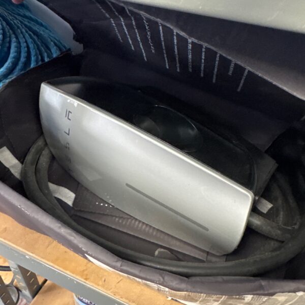 Tesla Wall Connector charger for electric vehicle home charging.