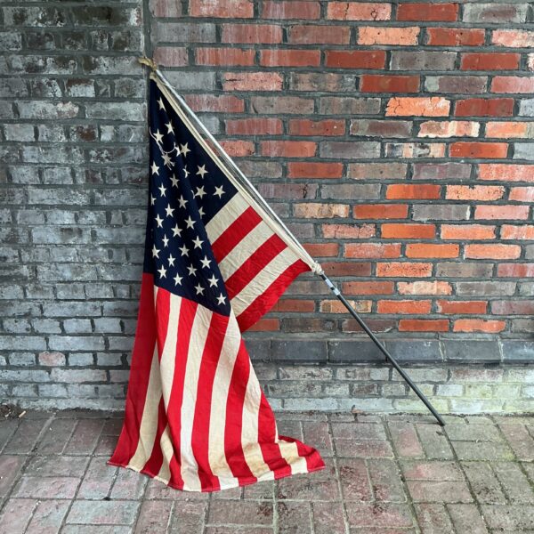 Vintage American flag on pole, stars and stripes Americana.