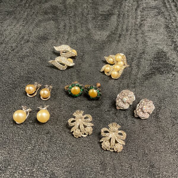 Vintage clip-on earrings lot featuring pearl and rhinestone designs.