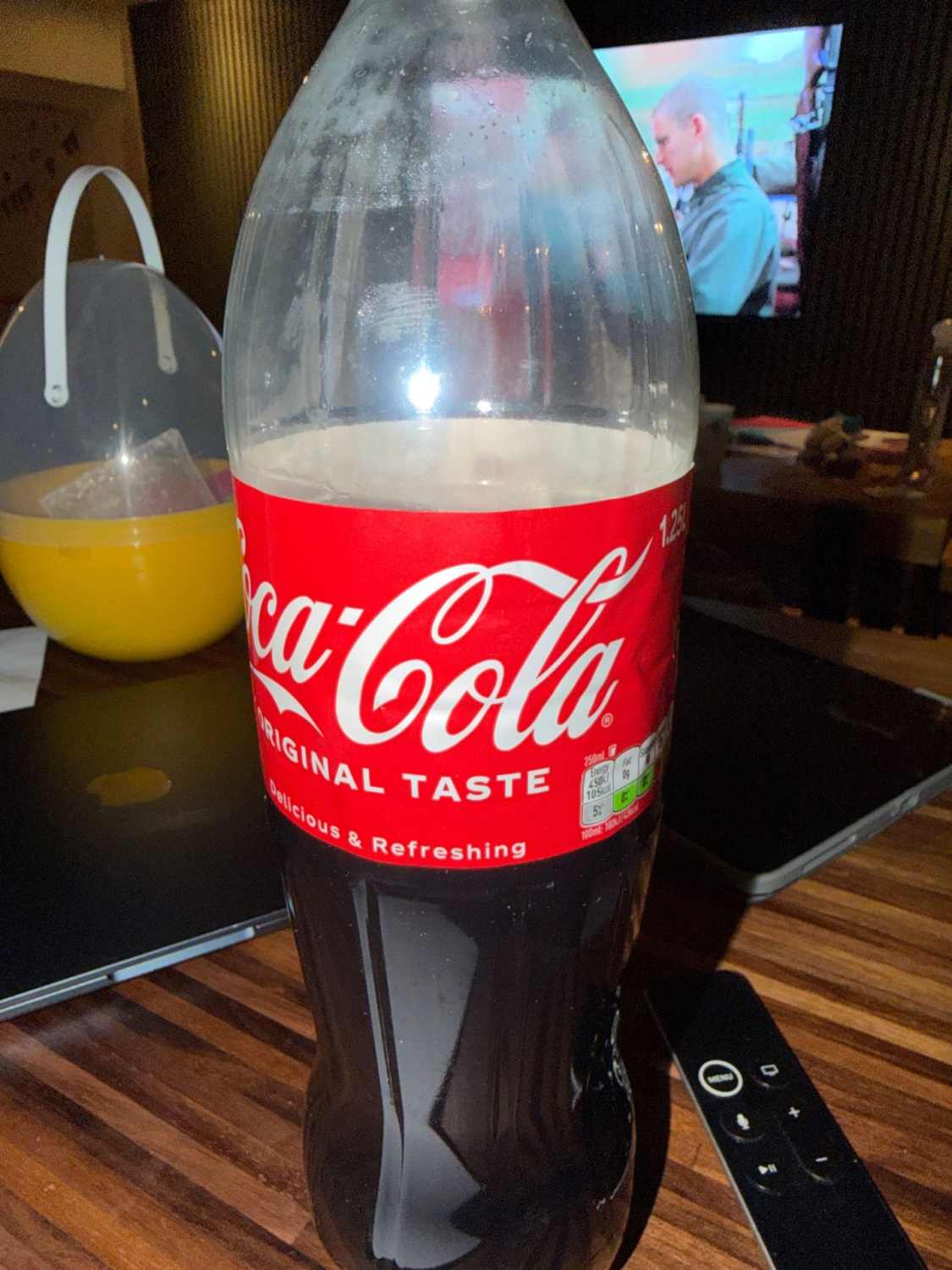 Full view of a vintage Coca-Cola plastic bottle.