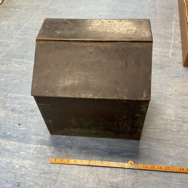 Vintage metal log bin for firewood storage with rustic patina.
