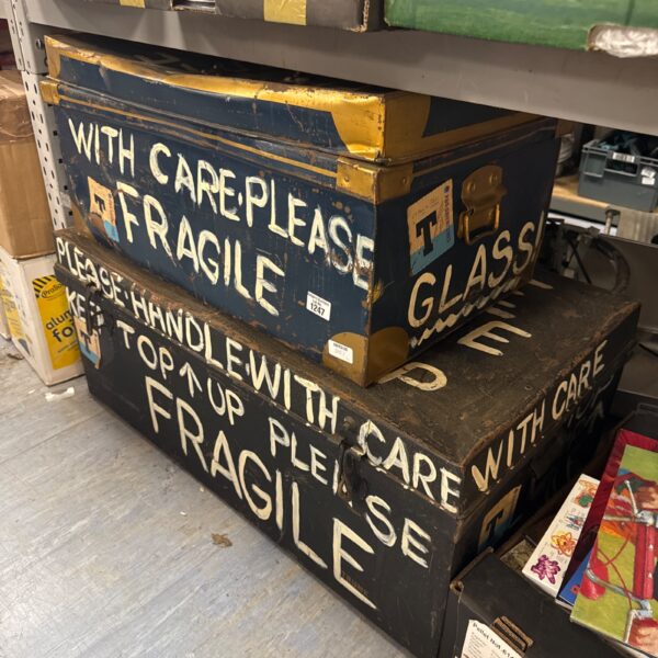 Blue vintage metal storage trunks with weathered patina.