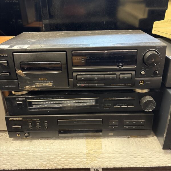 Vintage Aiwa, Yamaha & Sansui stereo system components in a classic setup.