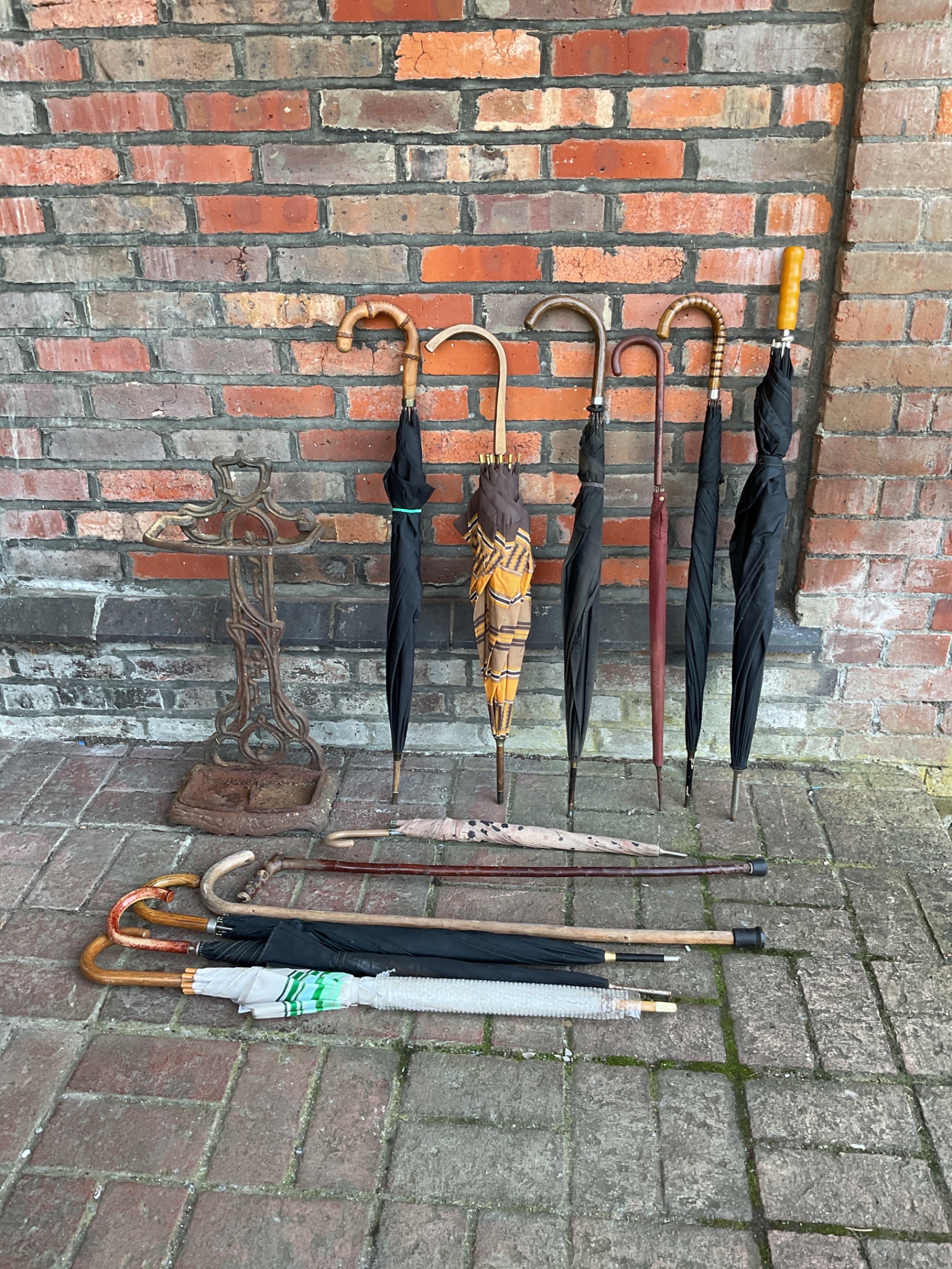 003 Victorian cast iron stick stand with collection of vintage umbrellas