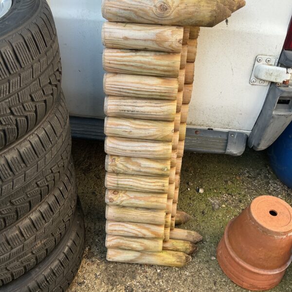 Three sets of wooden lawn edging for garden borders.