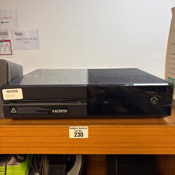 Black Microsoft Xbox One gaming console, side view.