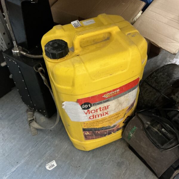 Yellow plastic container of mortar mix for building projects.
