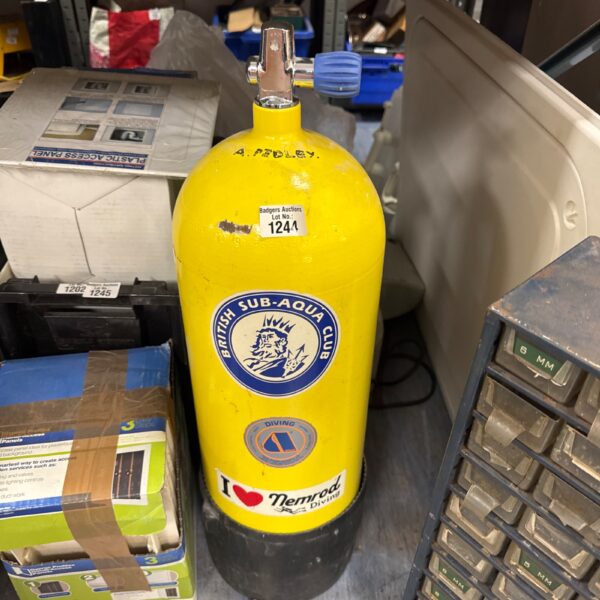 Yellow scuba diving tank with valve, vintage diving equipment.