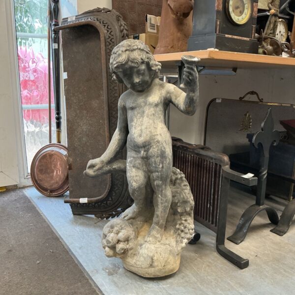 Victorian lead garden statue of a cherub standing on a fruit base